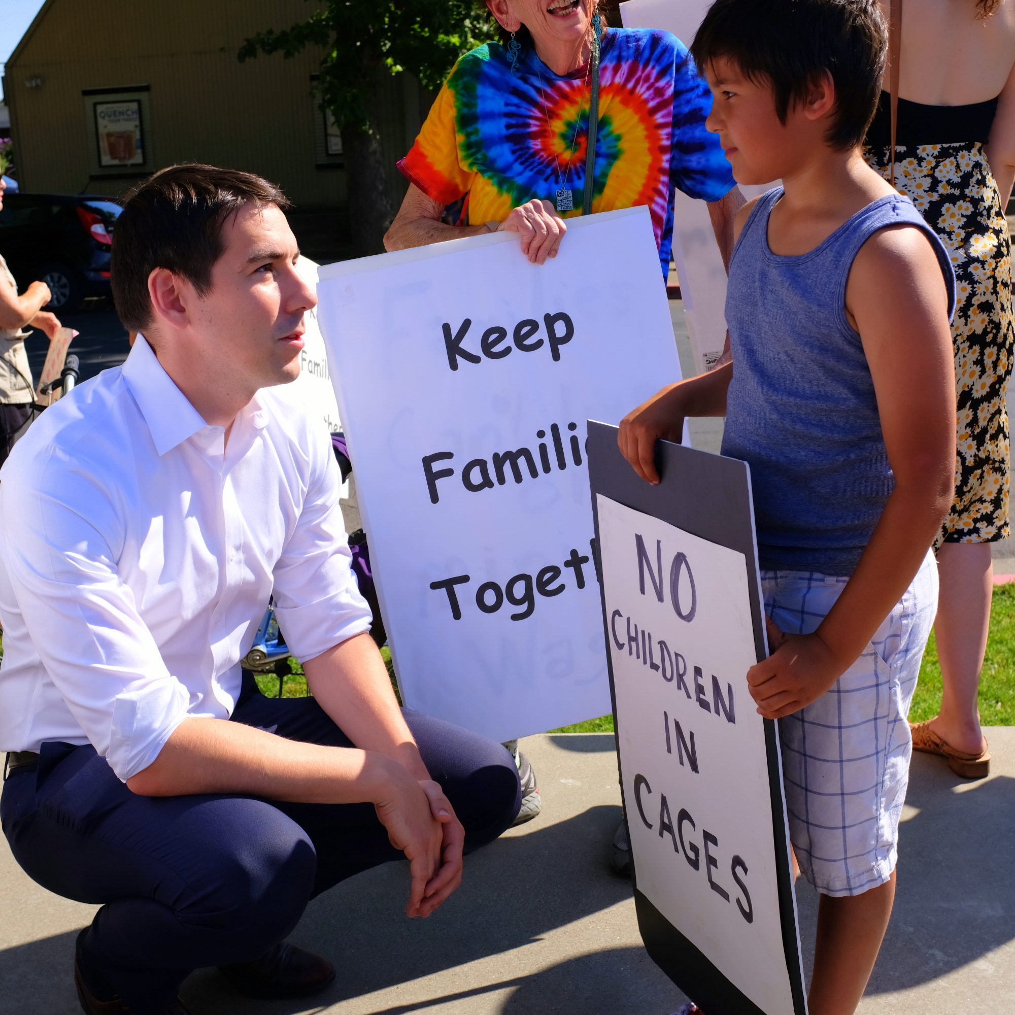 Josh Harder with boy holding sign, "No Children in Cages"