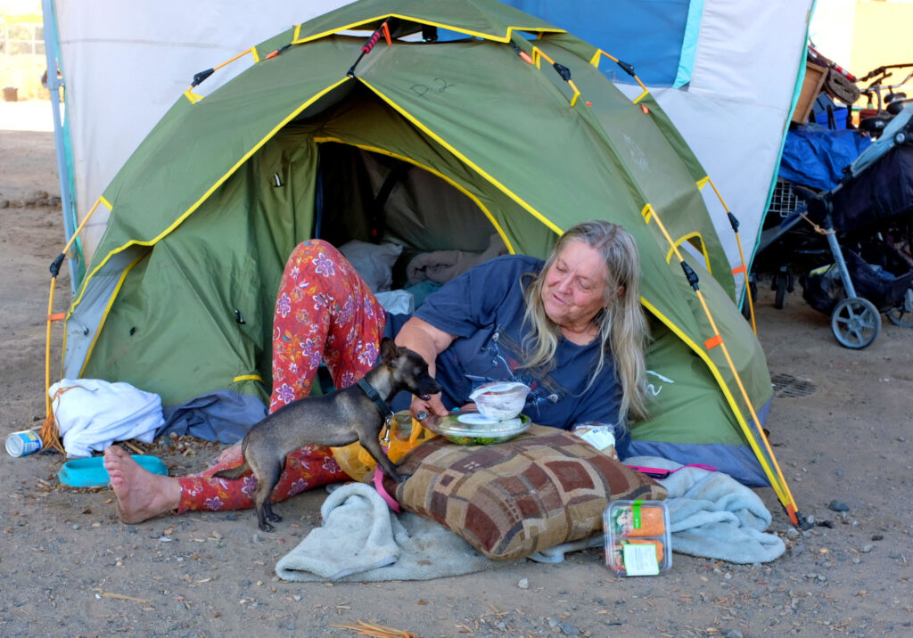 Woman in tent at Modesto Outdoor Emergency Shelter